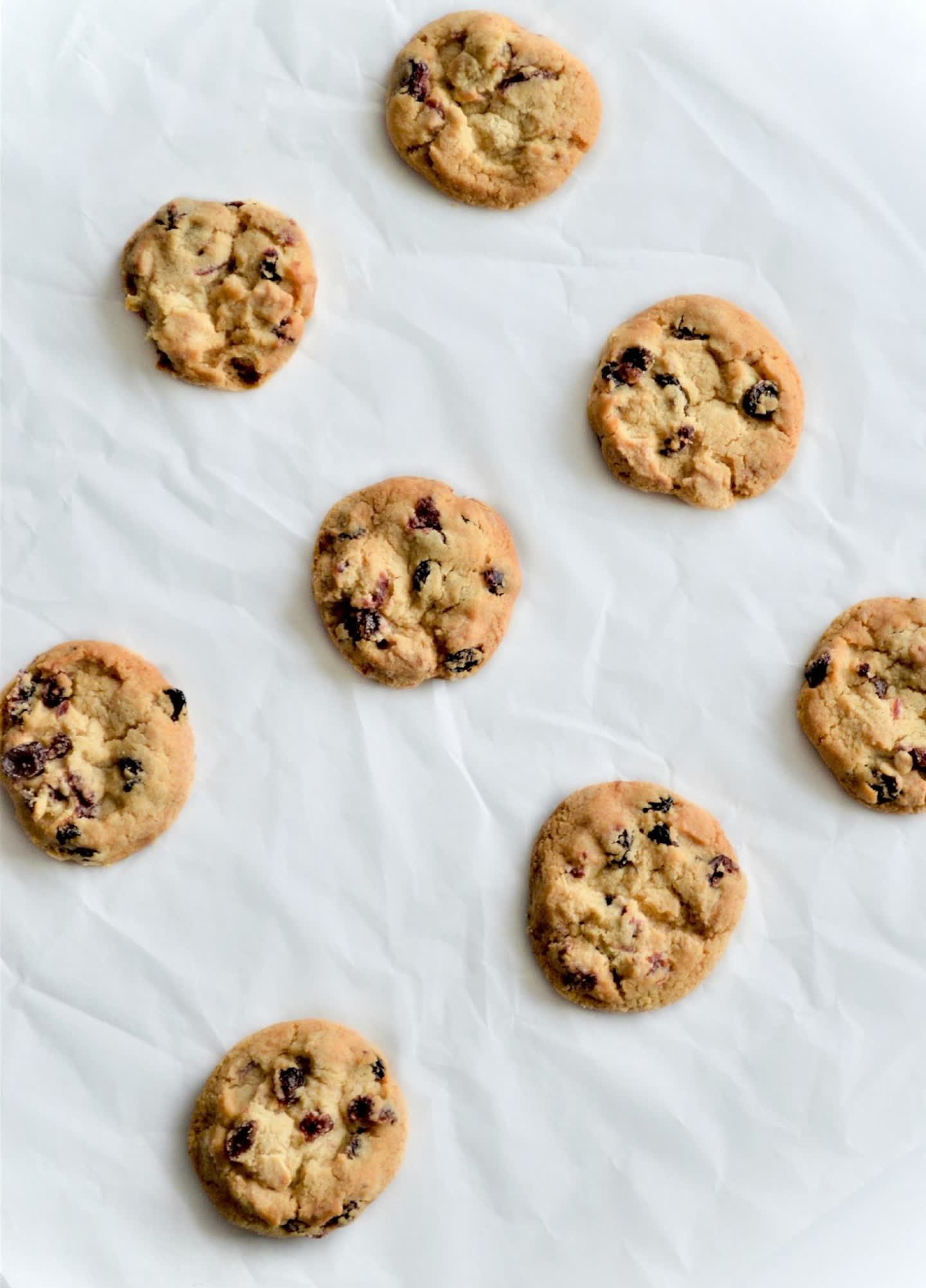 Freshly baked cookies laid out on parchment