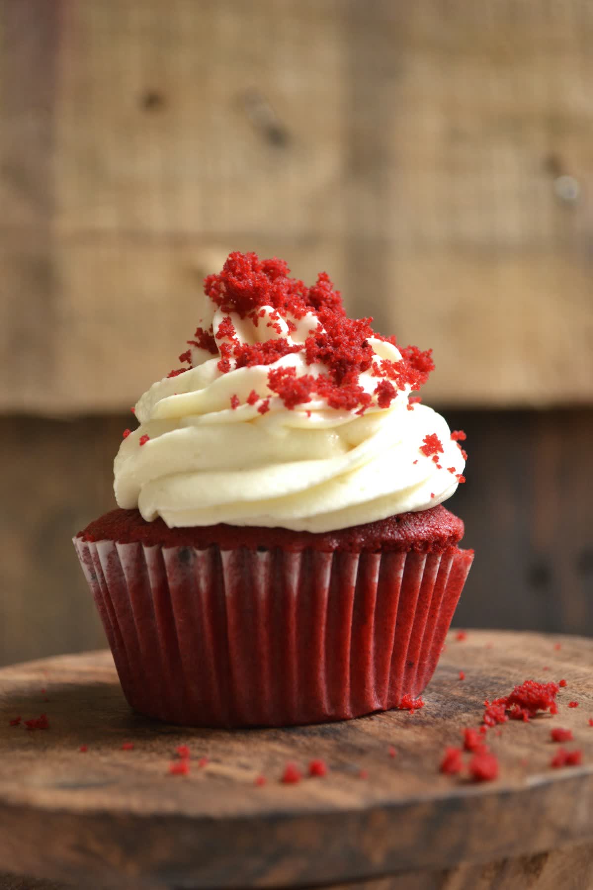 Red velvet cupcake with cream cheese frosting and crumb topping