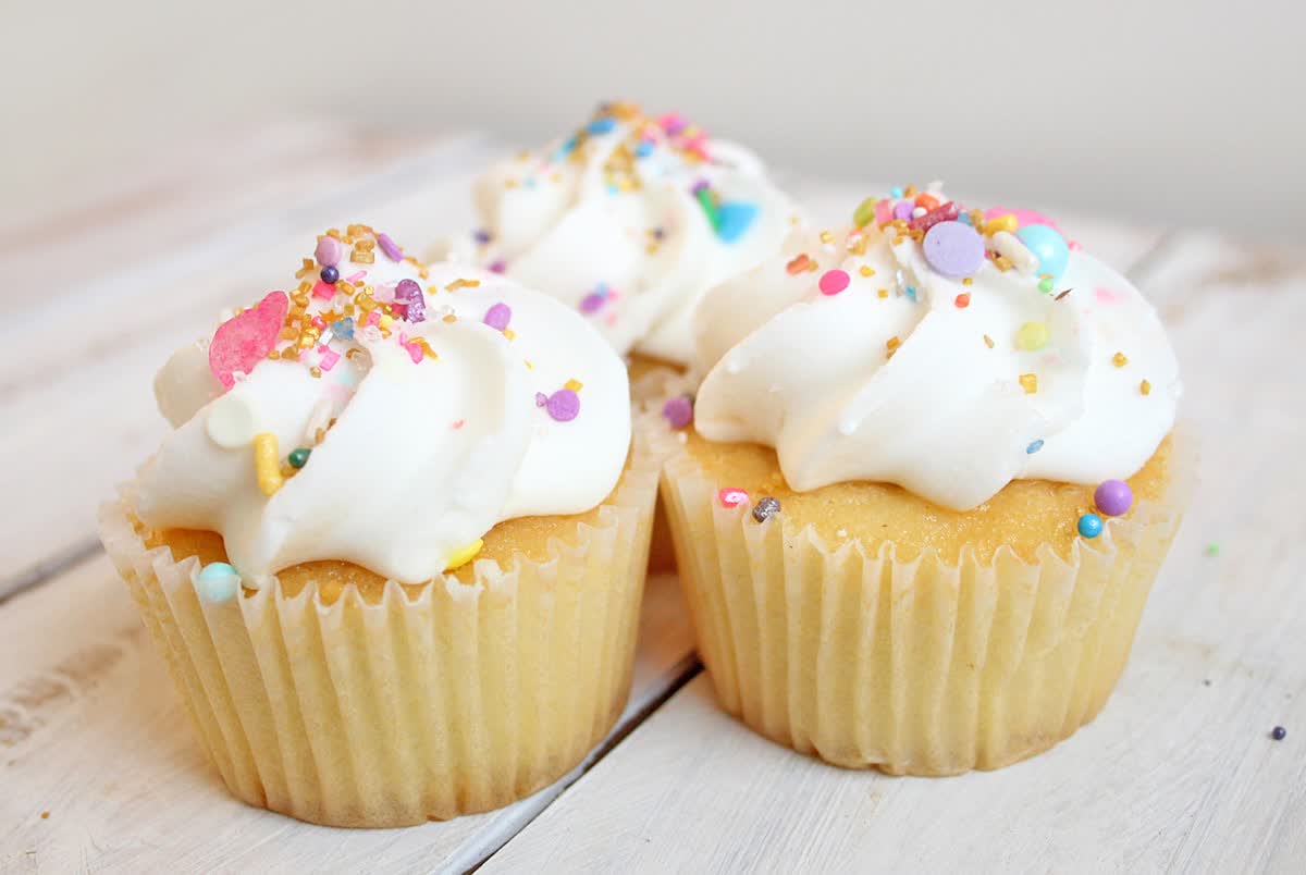 Vanilla cupcakes with white buttercream and heart sprinkles